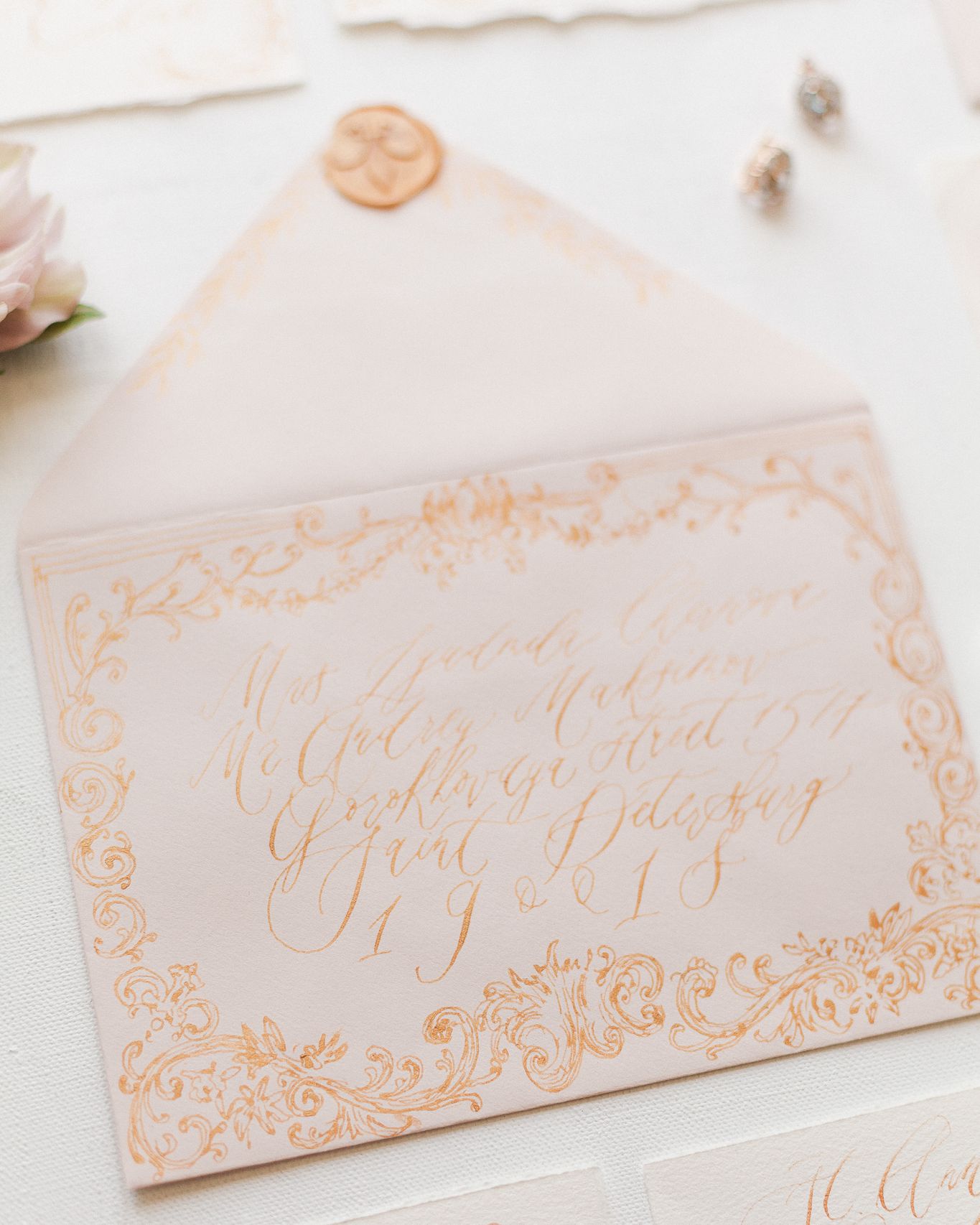 Green envelope with gold monogram